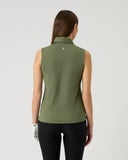 Woman wearing a green sleeveless top on a light gray background