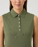 Woman wearing a green sleeveless polo shirt against a plain background