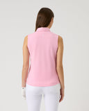 Woman wearing a pink sleeveless top and white pants on a light gray background