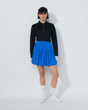 Person wearing a black top and blue skirt on a white background
