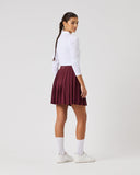 Person wearing a white shirt and maroon pleated skirt on a white background