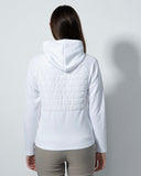 Person wearing a white quilted jacket against a gray background