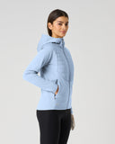 Daily Sports Allos Light Blue Hybrid Jacket in soft powder blue – women's hooded hybrid golf jacket side view showing zip hand pocket, quilted-to-fleece panel transition and tailored fit