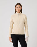 Woman wearing a beige jacket on a plain background