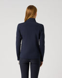 A woman viewed from the back wearing a dark navy long-sleeve mock-neck athletic top and matching navy pants against a plain light gray studio background.
