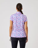 Person wearing a patterned shirt and dark pants on a light gray background