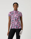 Person wearing a pink and black patterned shirt with black pants on a white background