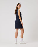 Woman wearing a navy sleeveless dress on a white background