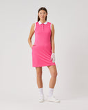 Woman wearing a pink dress with a white collar on a light gray background