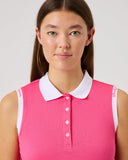 Woman wearing a pink sleeveless polo shirt with a white collar on a plain background