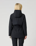A model viewed from the back wearing a black hooded jacket with a drawstring waist and black pants, set against a plain light gray studio background.
