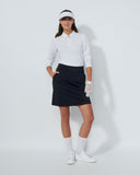Woman in golf attire on a white background
