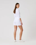 Person wearing a white outfit on a plain background