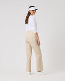 Woman wearing a white shirt, beige pants, and a visor on a white background