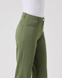 Green pants worn by a person on a white background