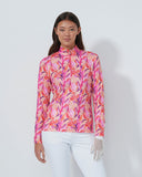 Woman wearing a colorful floral blouse against a white background