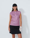 Woman wearing a sleeveless patterned top and black skirt on a white background