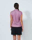 Person wearing a sleeveless patterned top and black skirt on a white background