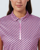 Woman wearing a sleeveless shirt with a geometric pattern on a plain background