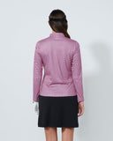 Person wearing a pink patterned blouse and black skirt on a white background