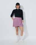 Person wearing a black top, pink skirt, and white shoes on a white background