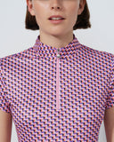 Person wearing a patterned shirt with a plain background