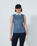 Woman wearing a blue patterned sleeveless top and black pants on a white background