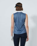 Woman wearing a blue patterned sleeveless top and black pants on a white background