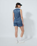 Person wearing a blue patterned dress and black visor on a white background