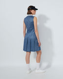 Person wearing a blue patterned dress and black cap on a white background