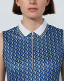 Woman wearing a blue geometric patterned sleeveless top with a white collar.