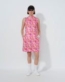 Person wearing a pink floral dress on a white background
