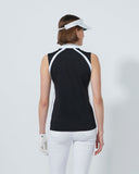 Woman wearing a black and white sleeveless top with a visor on a light gray background