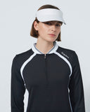 Woman wearing a black and white golf shirt with a visor on a light gray background