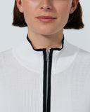 Person wearing a white jacket with a black zipper on a plain background
