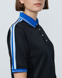 Person wearing a black polo shirt with blue and white accents on a plain background