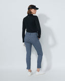 Person wearing a black top and patterned pants on a white background