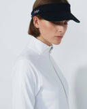 Person wearing a black visor with a brand logo on a light gray background