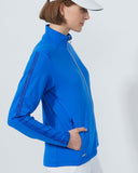 Person wearing a blue jacket and white cap on a light gray background