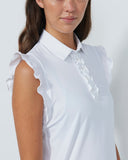 Woman wearing a white sleeveless blouse with ruffled sleeves on a plain background