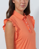 Woman wearing an orange sleeveless blouse with ruffled shoulders against a white background