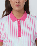 Woman wearing a pink and white striped polo shirt with a small logo on a plain background