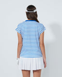 Woman wearing a blue and white striped shirt and white skirt on a plain background