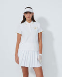 Person wearing a white tennis outfit with a visor on a plain background