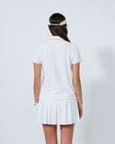 Person wearing a white tennis outfit on a plain background