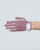 Hand wearing a purple and white checkered glove on a light gray background