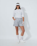 Person wearing a white shirt, checkered shorts, and visor on a white background