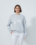 Person wearing a gray sweatshirt with 'Golf' text on a plain background