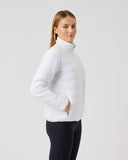 Woman wearing a white puffer jacket on a light gray background