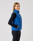 Person wearing a blue puffer vest on a white background